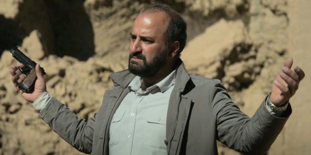 iman-missagh-zareh-holding-a-gun-in-the-seed-of-the-sacred-fig.jpg